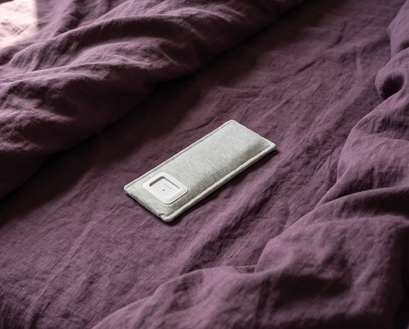 The Drowsie V3 in its washable sleeve, lying flat on the bed