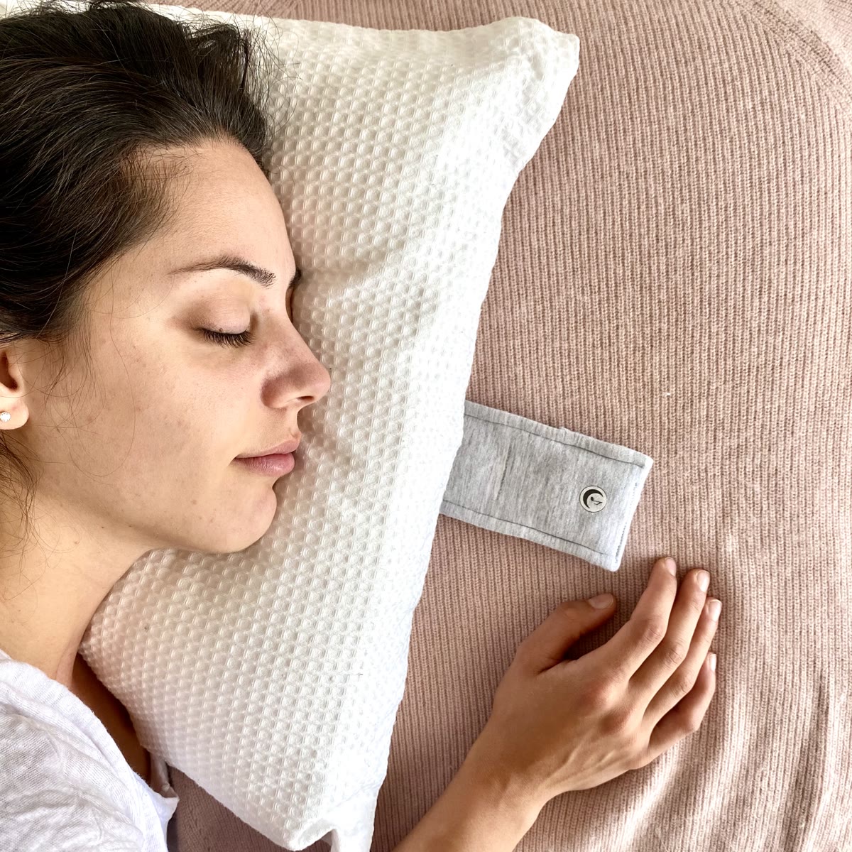 Woman sleeping peacefully with Drowsie pillow speaker